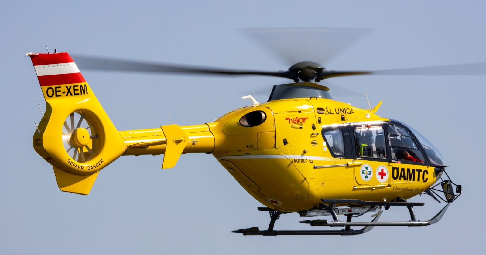 yellow helicopter of the ÖAMTC in action in the air